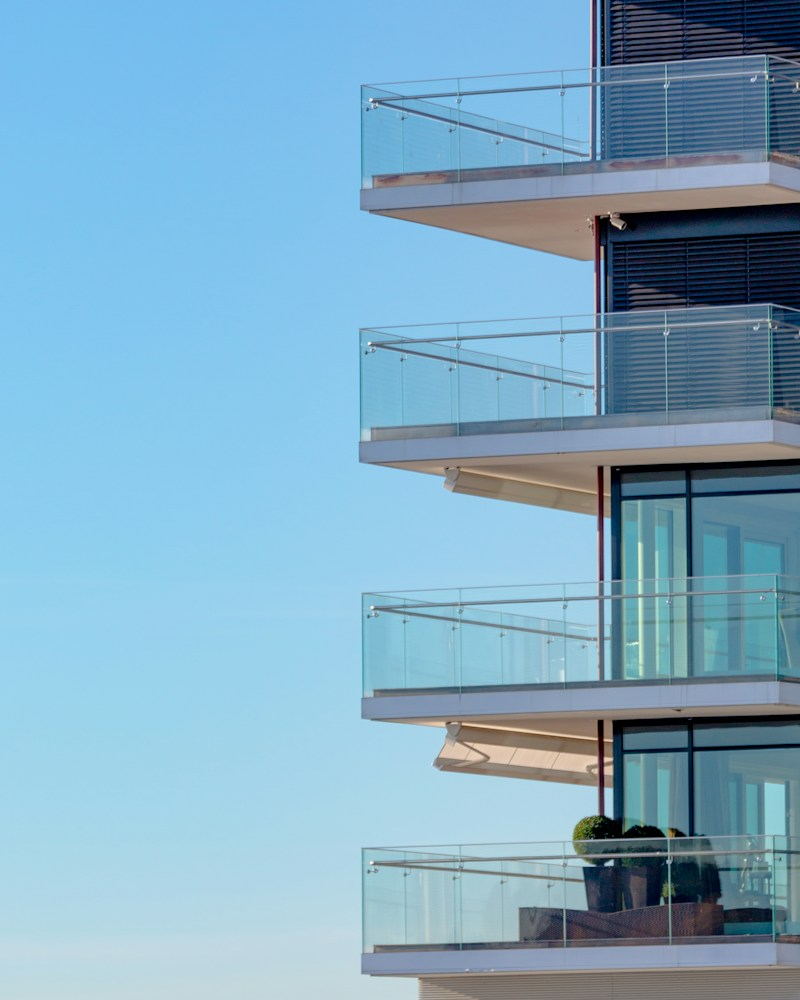 Stacked glass balconies on a modern residential building